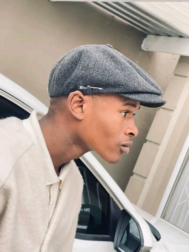 Portrait of Dzana wearing a flat cap and neutral clothing