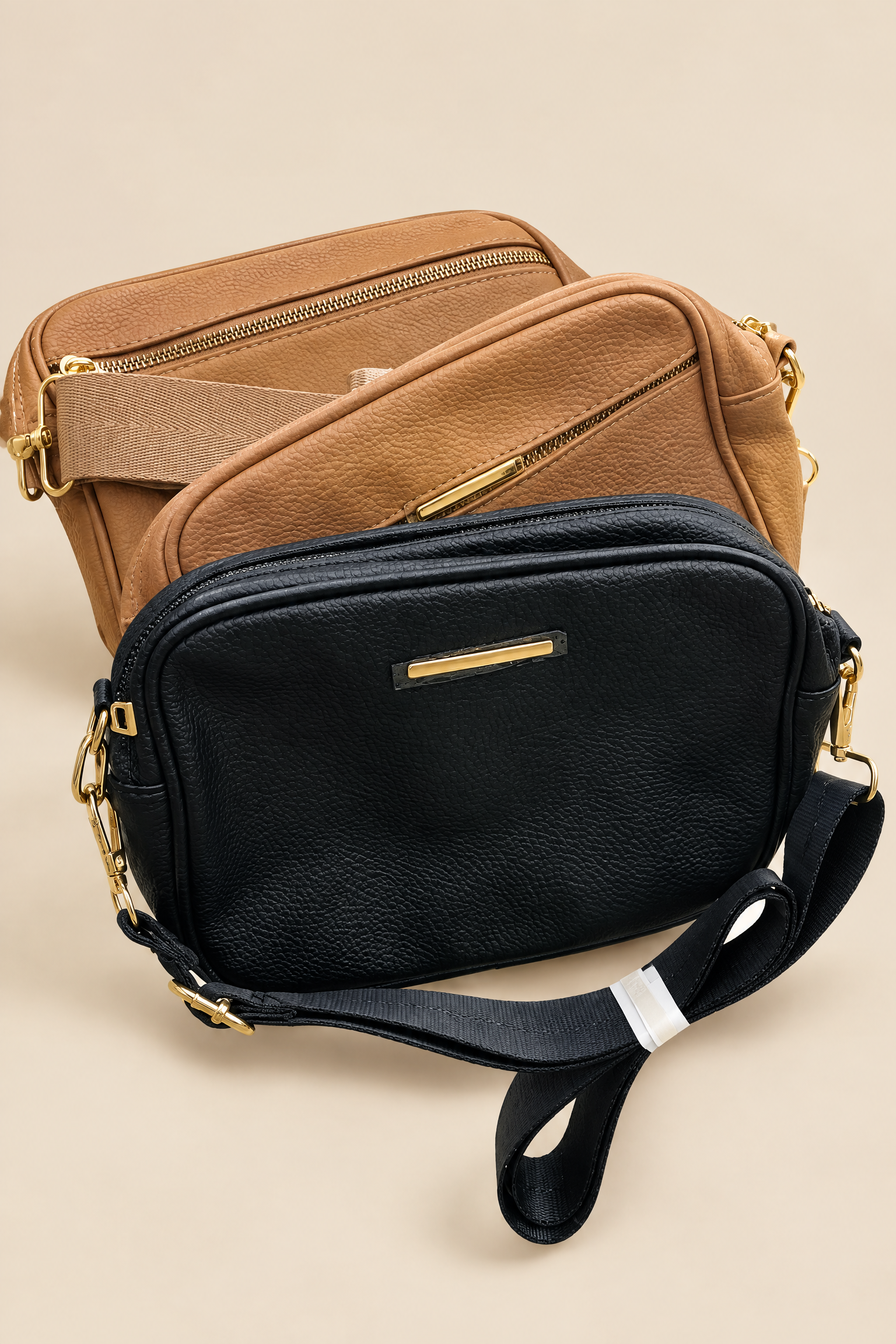 Black and tan compact shoulder bags